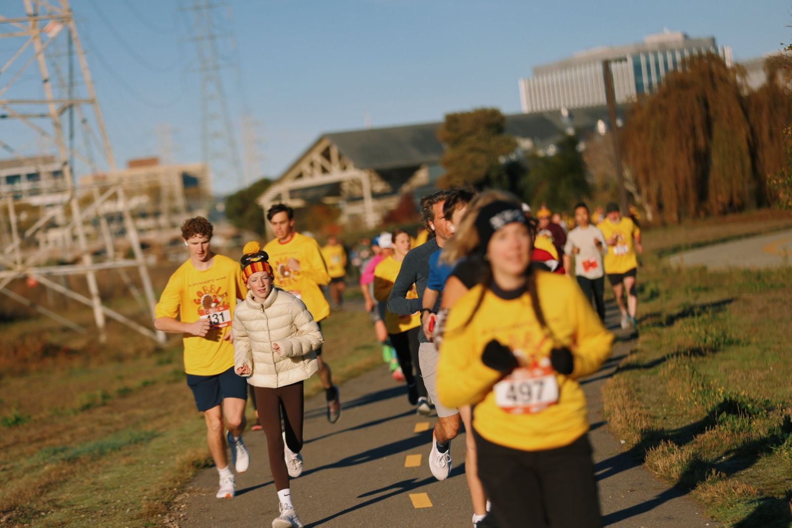 Runners in yellow Gobble Wobble shirts on the bay trail
