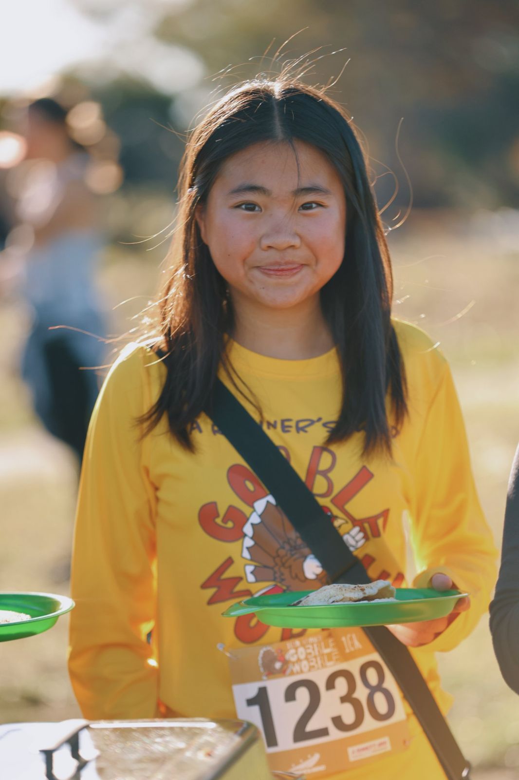 Runner holding a plate of pancakes after the race